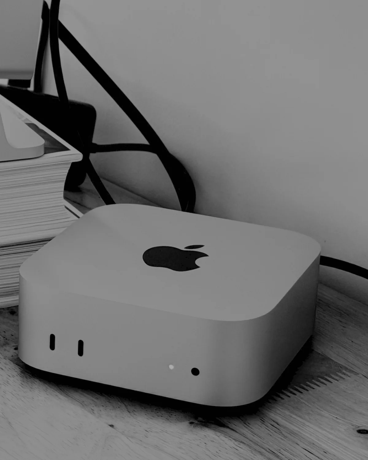 An Aumen edit station — Mac Studio on a wooden desk, cables routed, post-production kit in working order.